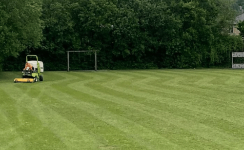 Operative on a ride on mower, mowing a large field